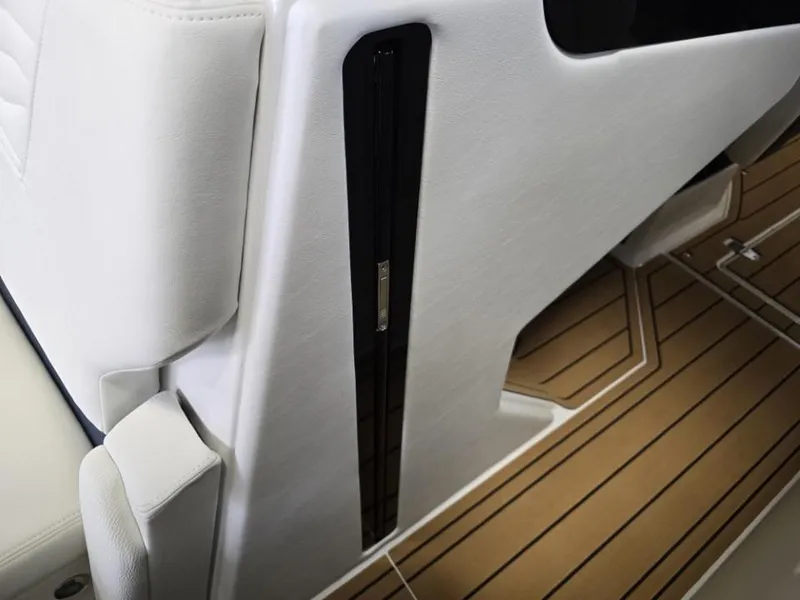 Slide: The Image of 2025 Nautique Super Air Nautique G23 interior with white upholstery and teak-style flooring. - 8