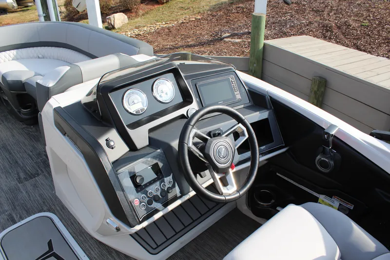 Slide: The Image of 2025 Tahoe Pontoon Cascade QLS dashboard with steering wheel and control panel. - 7