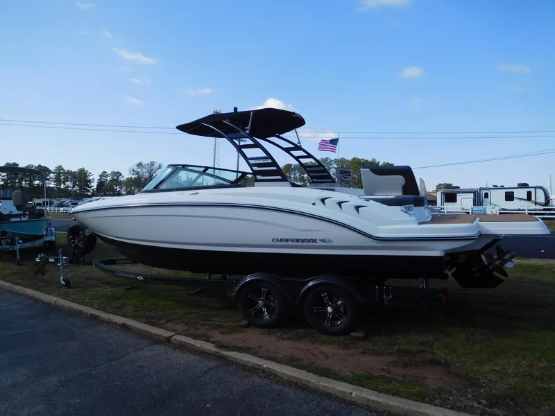 Slide: The Image of 2025 Chaparral 23 SSi boat on trailer, parked outdoors under clear sky. - 1