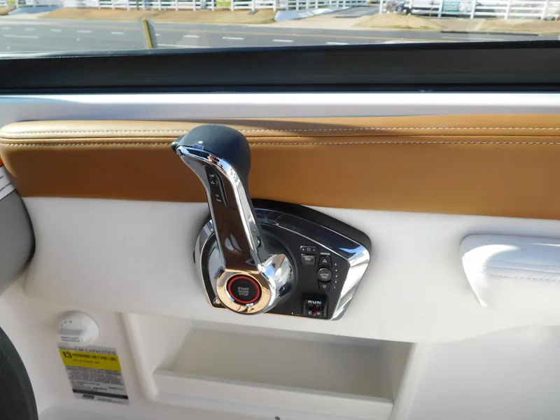 Slide: The Image of 2025 Chaparral 23 SSi boat throttle control with sleek design and leather trim. - 3