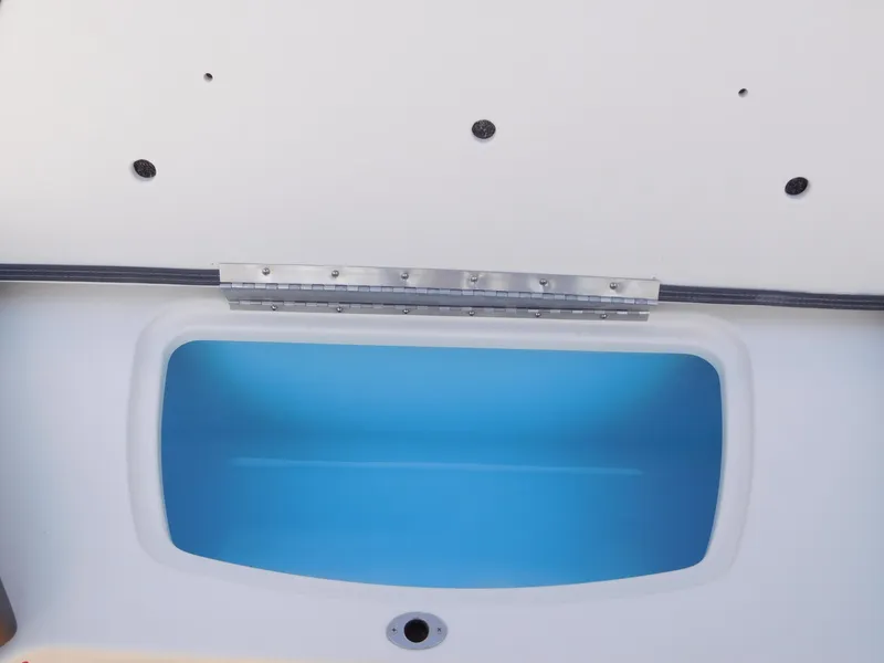 Slide: The Image of 2025 Chaparral 23 SSi boat storage compartment with blue interior. - 5