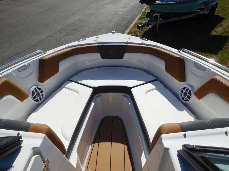 Slide: The Image of 2025 Chaparral 23 SSi boat interior with cushioned seating and speakers. - 6