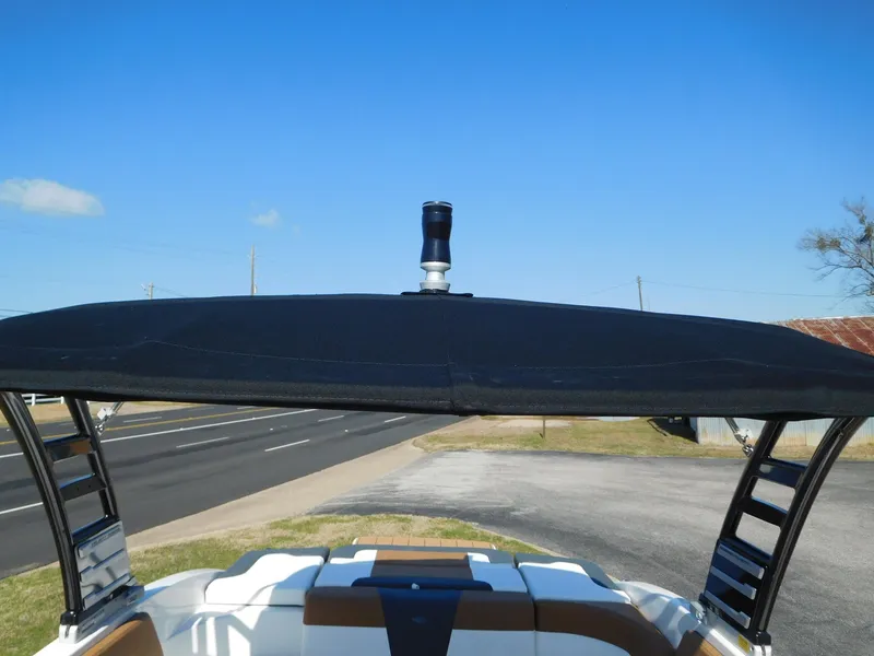 Slide: The Image of 2025 Chaparral 23 SSi boat with black bimini top on a sunny day. - 8