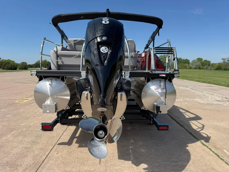 Slide: The Image of 2025 Barletta ARIA 22UC pontoon boat with powerful outboard motor, parked on concrete surface. - 10