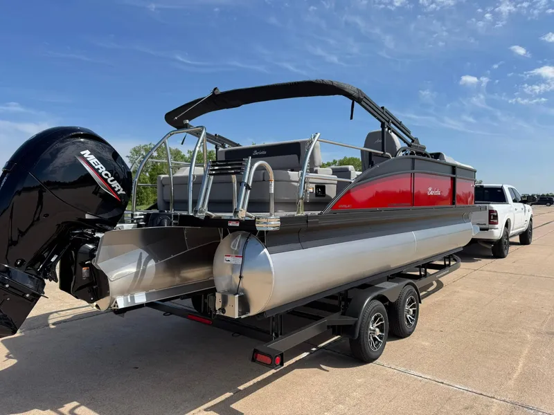 Slide: The Image of 2025 Barletta ARIA 22UC pontoon boat on trailer, featuring a Mercury outboard motor. - 12