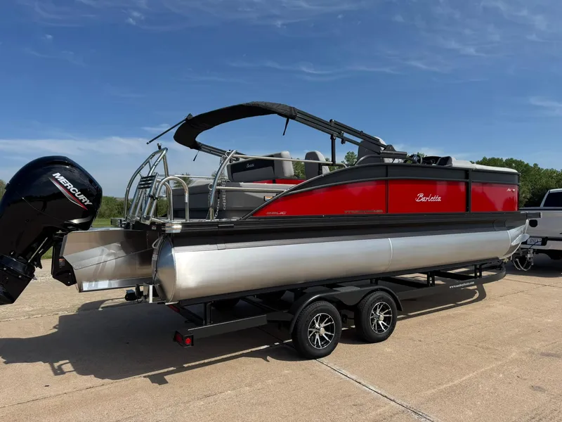 Slide: The Image of 2025 Barletta ARIA 22UC pontoon boat on trailer, featuring sleek red and silver design. - 13