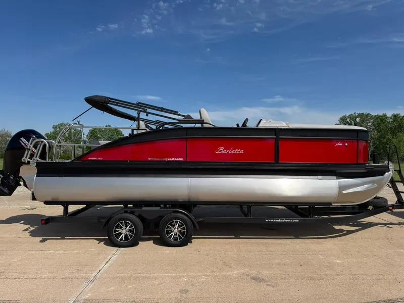 Slide: The Image of 2025 Barletta ARIA 22UC pontoon boat on trailer, red and silver design. - 14