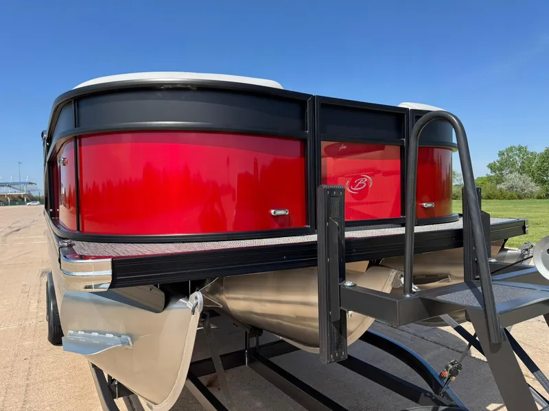Slide: The Image of 2025 Barletta ARIA 22UC pontoon boat with vibrant red exterior on a trailer. - 17