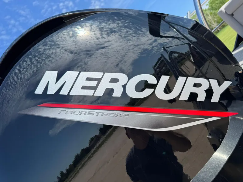 Slide: The Image of Mercury FourStroke engine on 2025 Barletta ARIA 22UC boat, reflecting clear sky. - 20