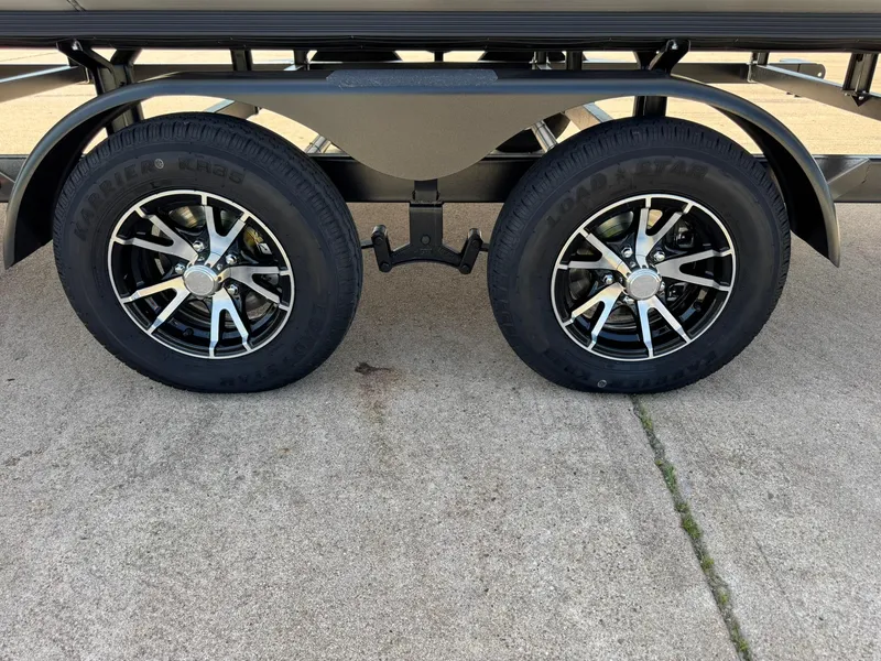 Slide: The Image of 2025 Barletta ARIA 22UC trailer wheels on concrete surface. - 22