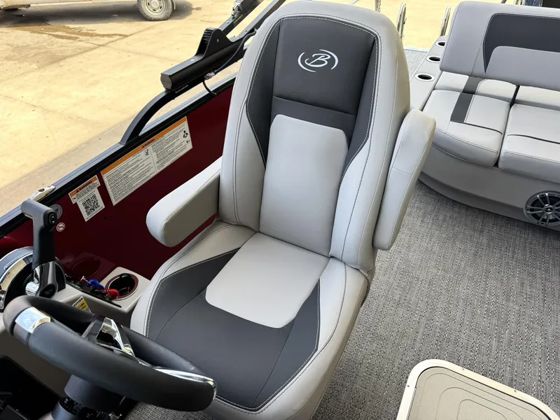 Slide: The Image of 2025 Barletta ARIA 22UC boat interior with gray captain's chair and steering wheel. - 35