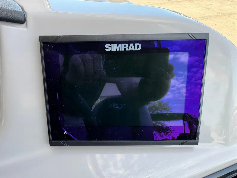 Slide: The Image of Simrad display on 2025 Barletta ARIA 22UC boat dashboard, reflecting sky and surroundings. - 38