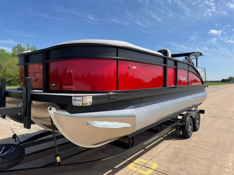 Slide: The Image of 2025 Barletta ARIA 22UC pontoon boat with red exterior on a trailer. - 4