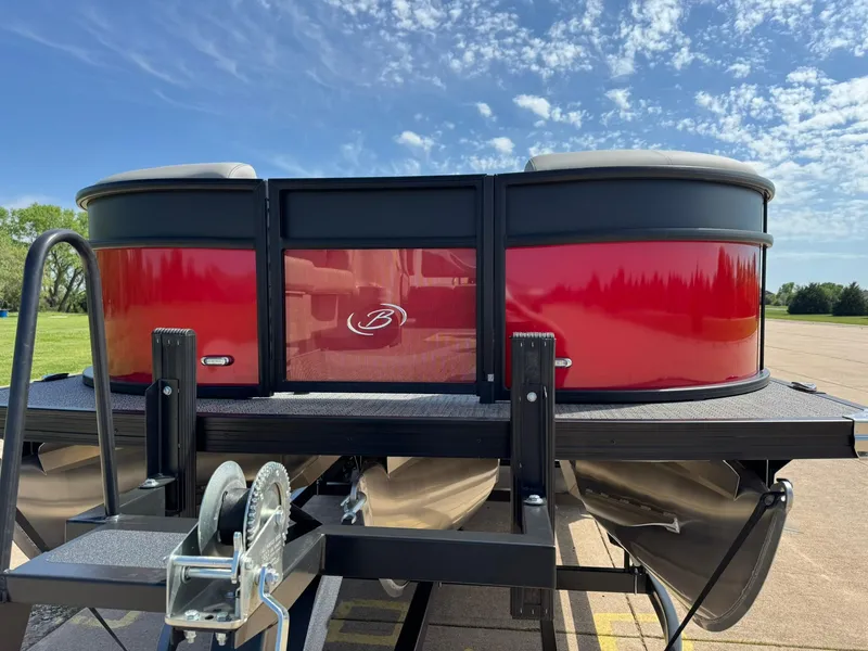 Slide: The Image of 2025 Barletta ARIA 22UC pontoon boat, red exterior, parked under a clear blue sky. - 6