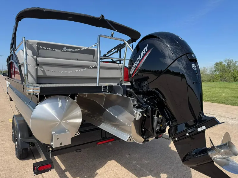 Slide: The Image of 2025 Barletta ARIA 22UC pontoon boat with Mercury outboard motor, parked on a trailer. - 9
