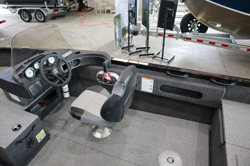 Slide: The Image of 2025 Crestliner 1750 Hawk SC boat interior with steering console and seating. - 11