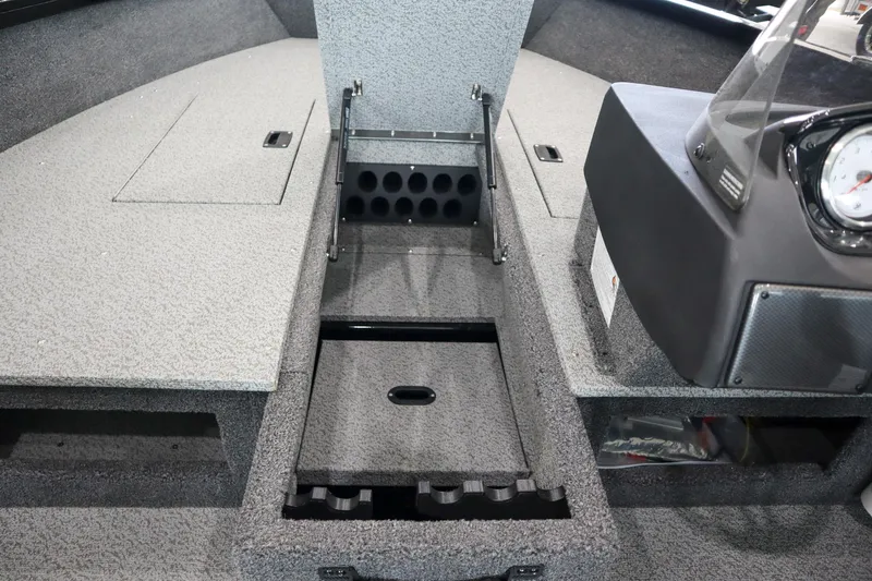 Slide: The Image of 2025 Crestliner 1750 Hawk SC boat interior with storage compartments and rod holders. - 13