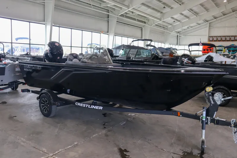Slide: The Image of 2025 Crestliner 1750 Hawk SC boat in showroom, black exterior, on trailer. - 3