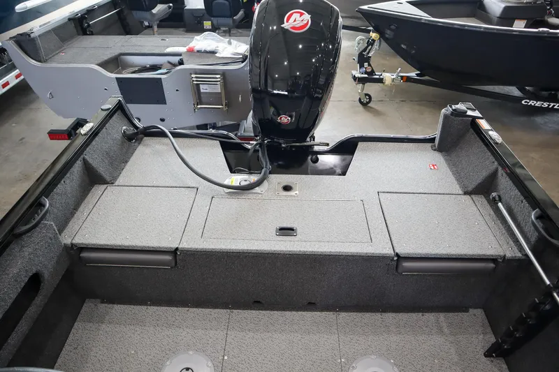 Slide: The Image of 2025 Crestliner 1750 Hawk SC boat interior with motor, showcasing spacious deck and storage compartments. - 7