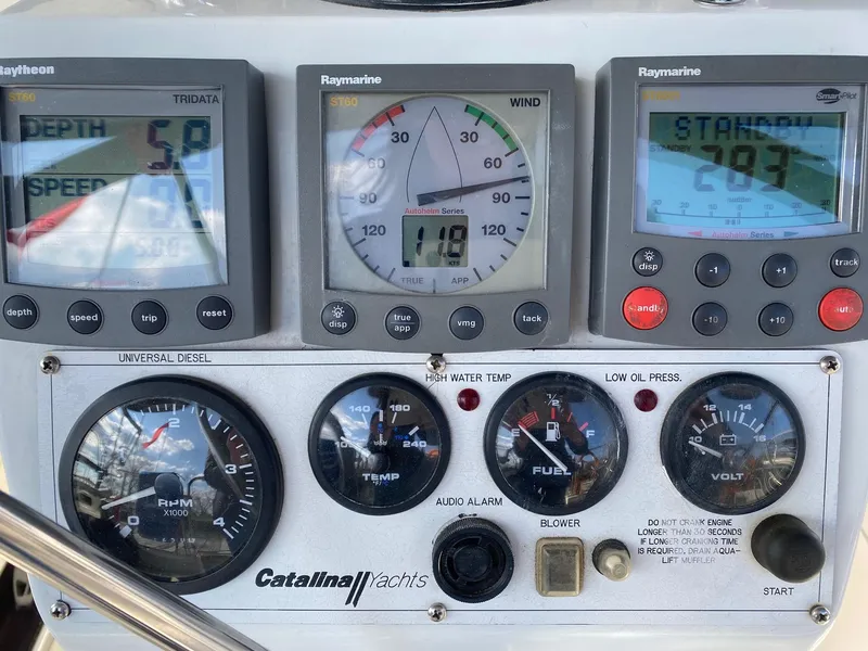 Slide: The Image of Control panel of a 2004 Catalina 350 yacht with various gauges and displays. - 17