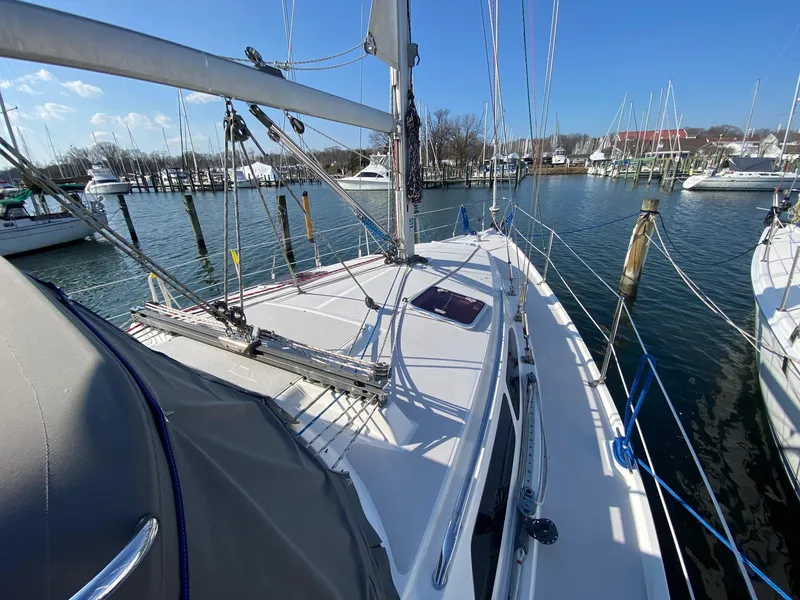 Slide: The Image of 2004 Catalina 350 sailboat docked in a marina under clear blue skies. - 20
