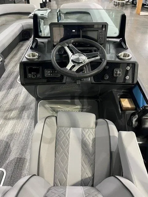 Slide: The Image of 2025 Bennington M 26 Swingback boat interior with modern steering and dashboard controls. - 10