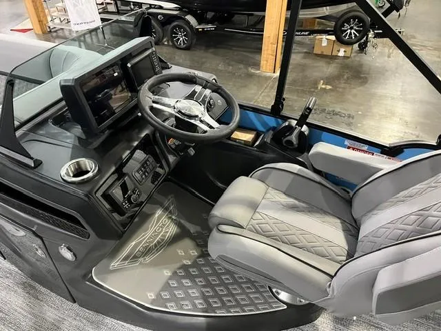Slide: The Image of 2025 Bennington M 26 Swingback boat interior with modern dashboard and seating. - 11