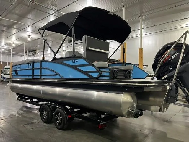 Slide: The Image of 2025 Bennington M 26 Swingback pontoon boat with canopy in a showroom. - 3