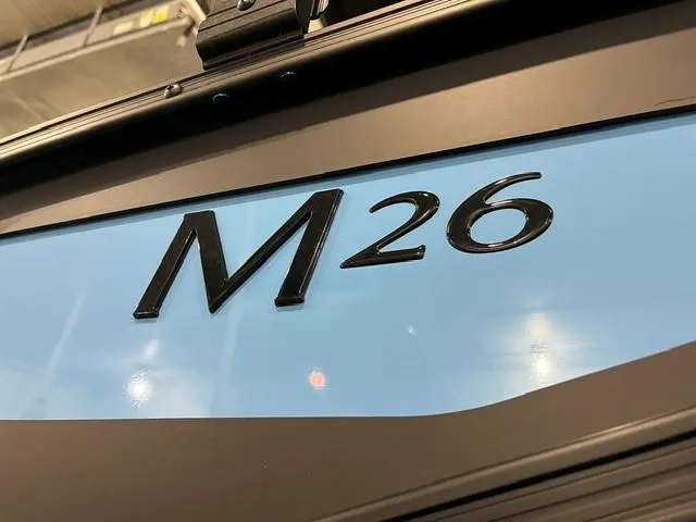 Slide: The Image of 2025 Bennington M 26 Swingback logo on sleek blue background. - 7