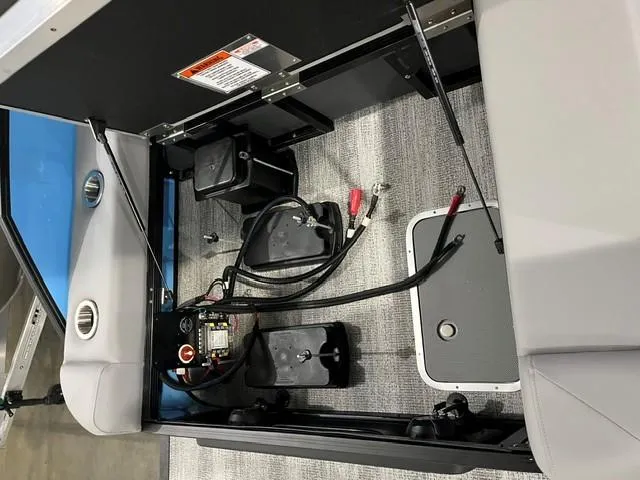 Slide: The Image of 2025 Bennington M 26 Swingback interior showing battery compartment and wiring setup. - 8