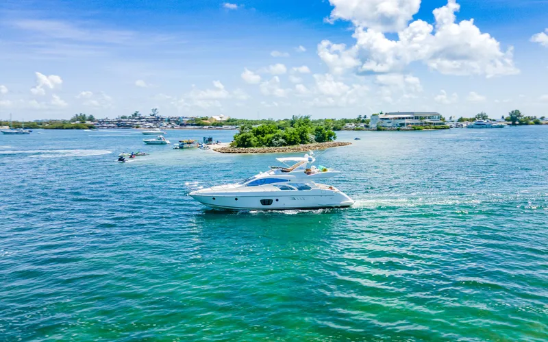 Slide: The Image of Azimut 55E yacht cruising on clear blue waters, 2005 model, under a sunny sky. - 14