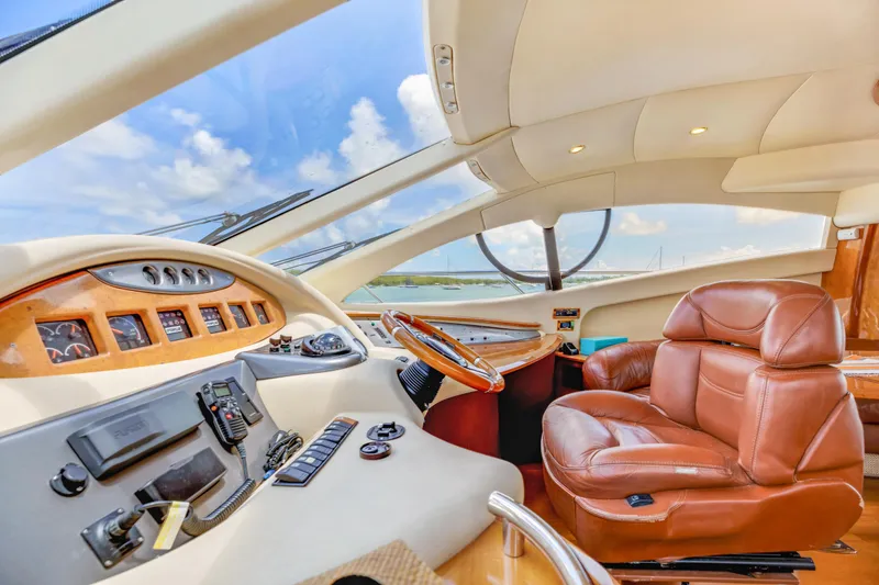 Slide: The Image of Luxurious 2005 Azimut 55E yacht interior with leather seating and modern dashboard. - 21