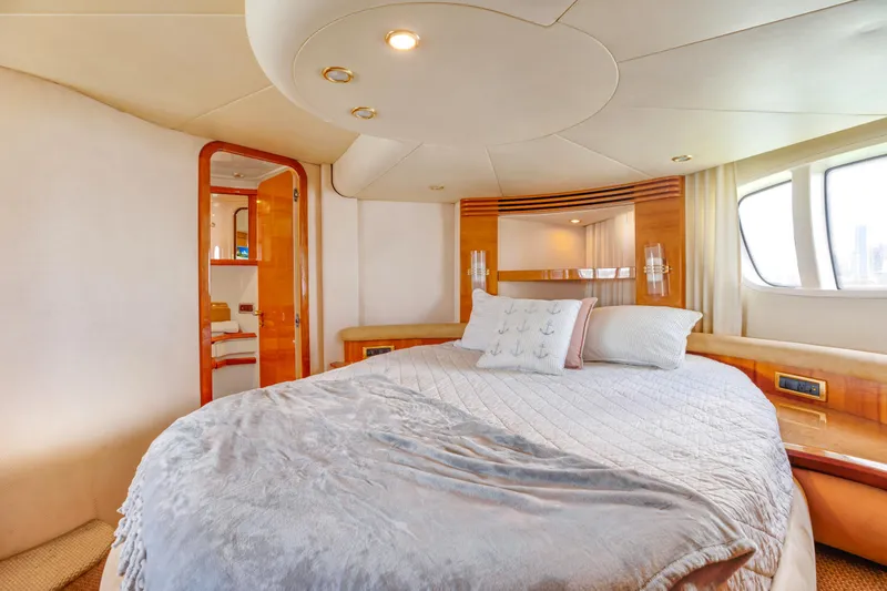 Slide: The Image of Luxurious bedroom interior of 2005 Azimut 55E yacht with cozy bedding and elegant design. - 24
