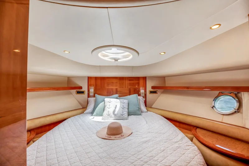 Slide: The Image of Luxurious cabin interior of a 2005 Azimut 55E yacht with elegant bedding and wood accents. - 30