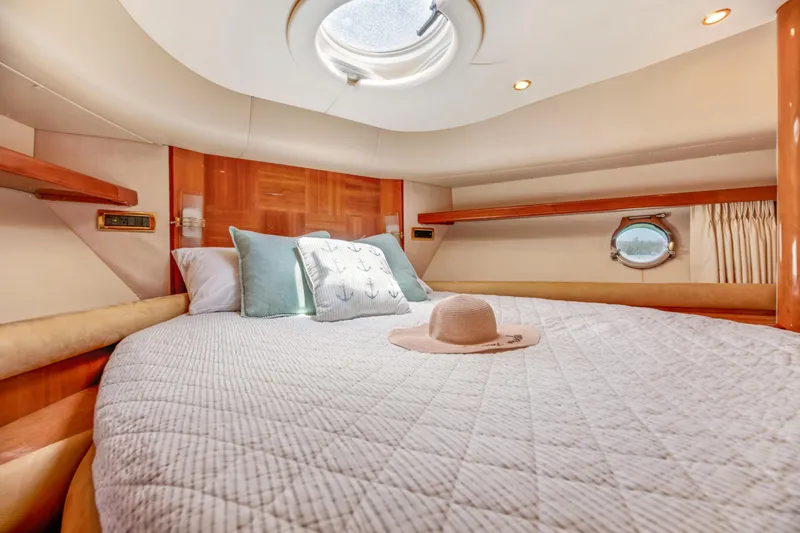 Slide: The Image of Luxurious bedroom interior of 2005 Azimut 55E yacht with cozy bedding and porthole view. - 32