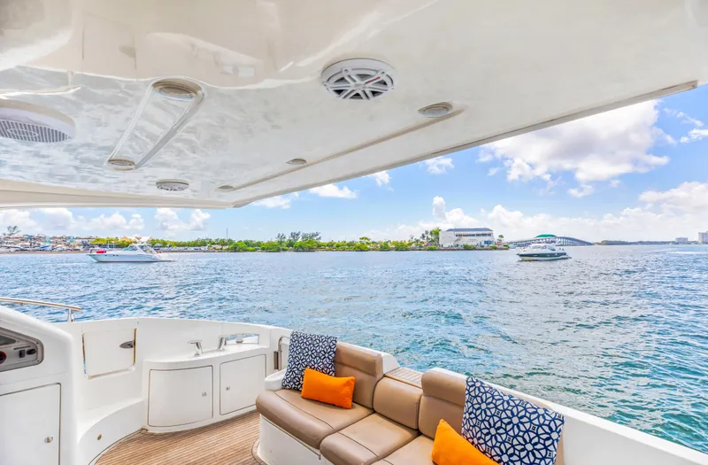 Slide: The Image of 2005 Azimut 55E yacht interior with ocean view, featuring comfortable seating and vibrant cushions. - 34