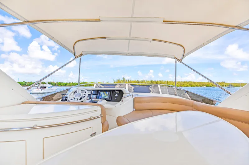 Slide: The Image of 2005 Azimut 55E yacht interior with helm, luxurious seating, and ocean view. - 36