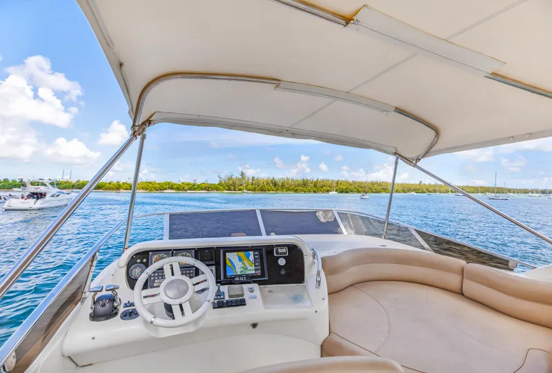 Slide: The Image of Cockpit view of 2005 Azimut 55E yacht on a sunny day, featuring navigation equipment. - 37