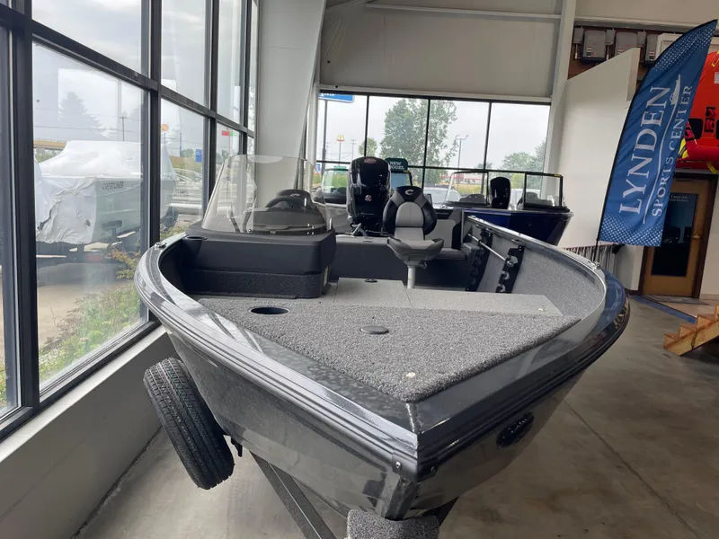 The Image of 2025 Crestliner 1750 Hawk SC boat displayed indoors at a dealership. - 0