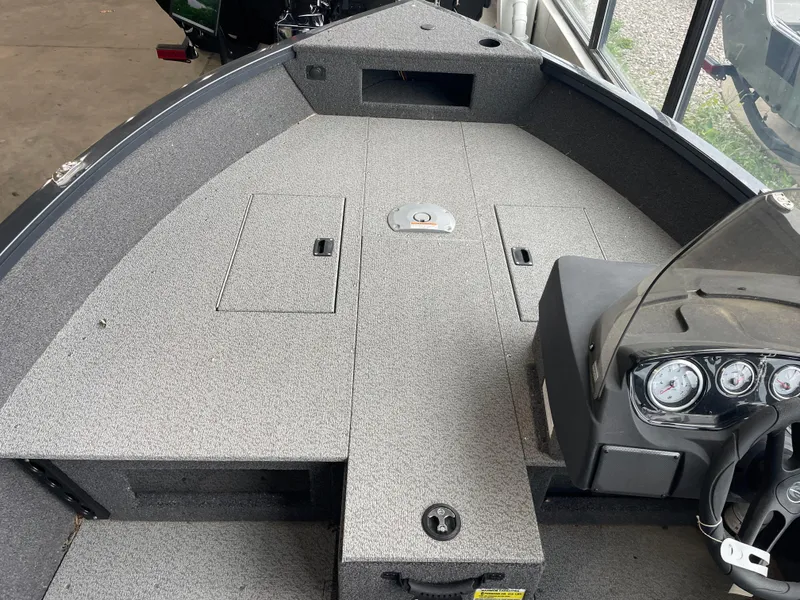 Slide: The Image of 2025 Crestliner 1750 Hawk SC boat interior with dashboard and storage compartments. - 4