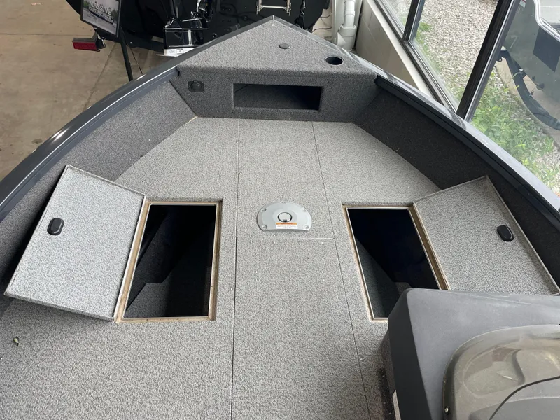 Slide: The Image of 2025 Crestliner 1750 Hawk SC boat interior with open storage compartments. - 5