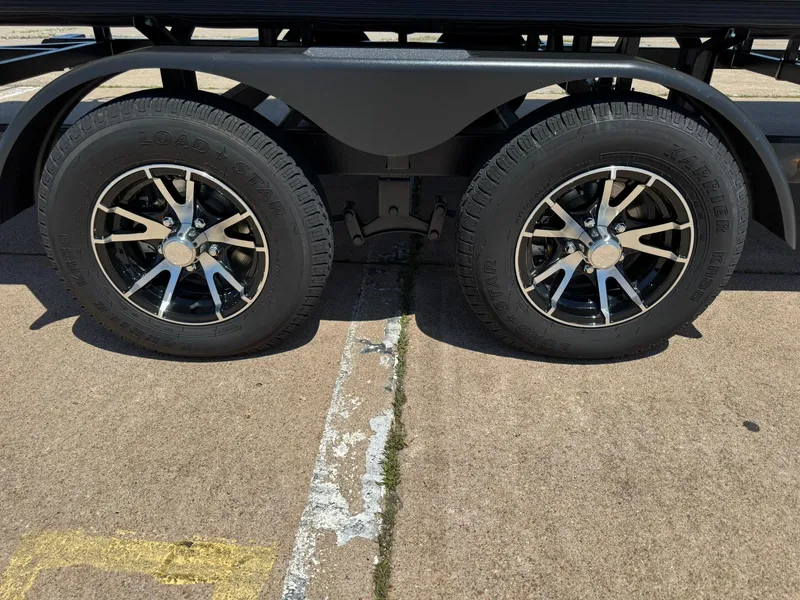 Slide: The Image of Dual wheels of a 2025 Barletta Cabrio 22UC on a concrete surface. - 15