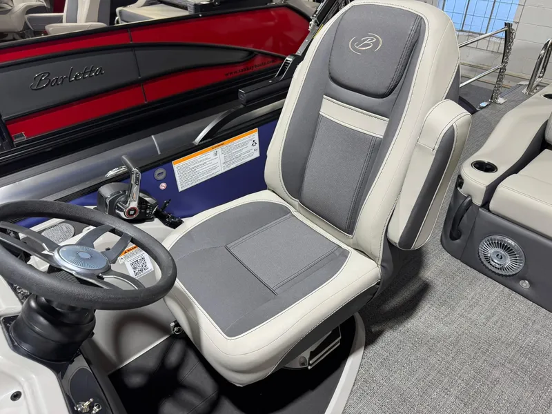Slide: The Image of 2025 Barletta Cabrio 22UC boat interior with steering wheel and comfortable captain's chair. - 26