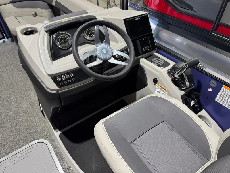 Slide: The Image of 2025 Barletta Cabrio 22UC boat cockpit with steering wheel and control panel. - 27