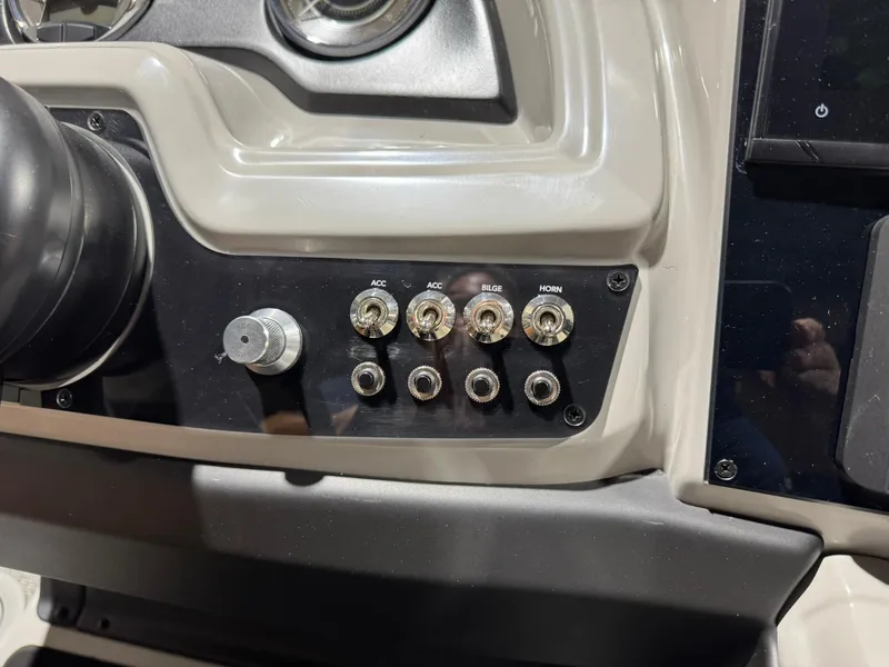 Slide: The Image of Control panel of 2025 Barletta Cabrio 22UC boat with switches and knobs. - 30