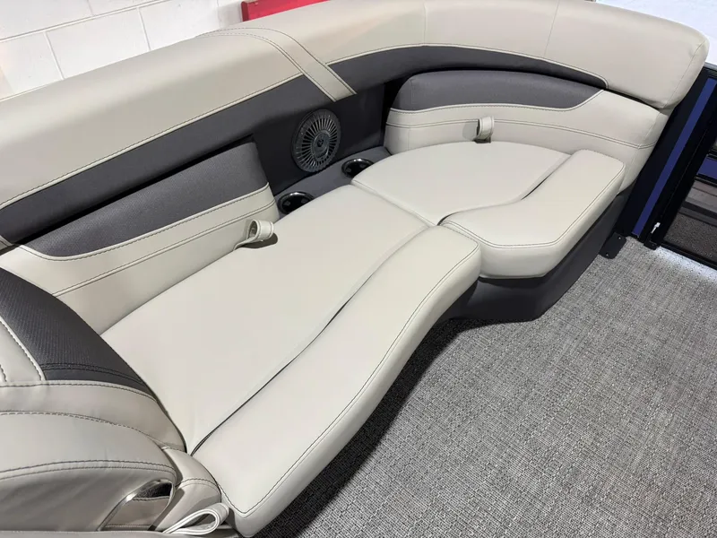 Slide: The Image of 2025 Barletta Cabrio 22UC boat interior seating with beige upholstery and integrated speaker. - 42