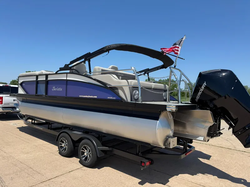 Slide: The Image of 2025 Barletta Cabrio 22UC pontoon boat on trailer, featuring Mercury outboard motor. - 7