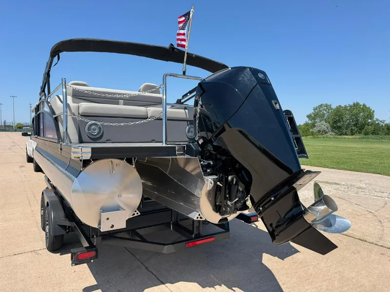 Slide: The Image of 2025 Barletta Cabrio 22UC pontoon boat with powerful outboard motor, parked on a sunny day. - 8