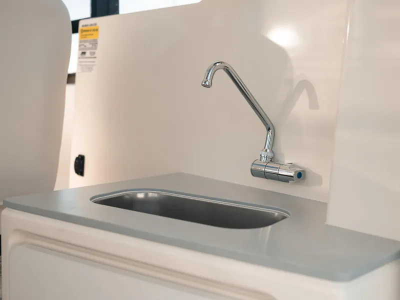 Slide: The Image of 2024 Bayliner Trophy T25PH boat interior sink with modern faucet design. - 10