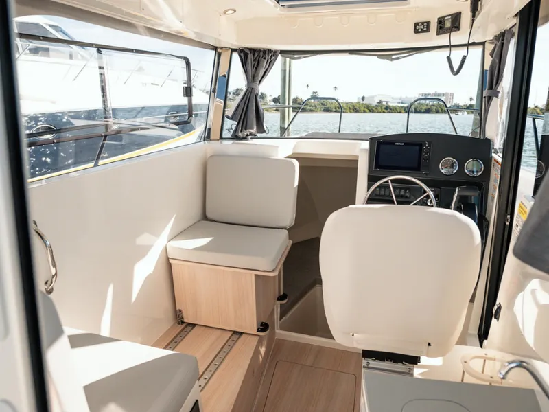 Slide: The Image of 2024 Bayliner Trophy T25PH boat interior with seating and navigation controls. - 15